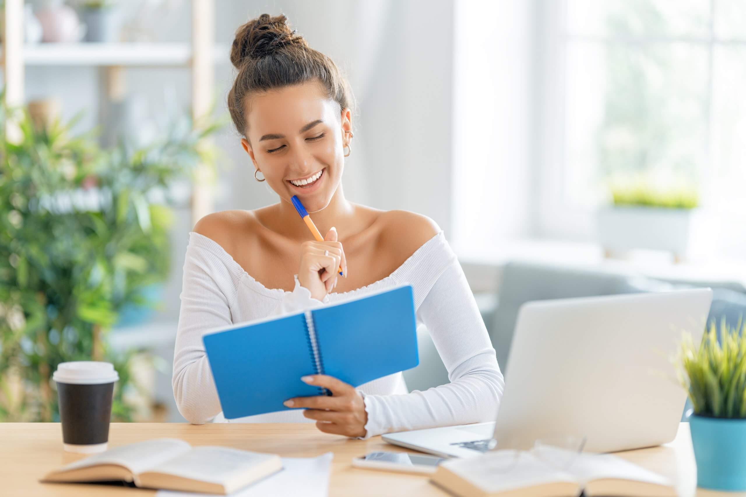 Happy Woman with Blue Notebook